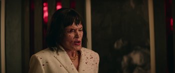 Movie still from “The Enforcer” (2022), directed by Richard Hughes – A woman with blood all over her face; Medium shot, Low angle