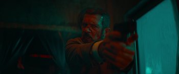 Movie still from “The Enforcer” (2022), directed by Richard Hughes – A man with blood all over his face and arm; Close Up shot, Low angle