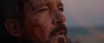 Movie still from “The Enforcer” (2022), directed by Richard Hughes – A person with a beard and a mustache; Extreme Close Up shot, Low angle