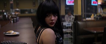Movie still from “The Equalizer” (2014), directed by Antoine Fuqua – A woman with black hair and red lipstick; Close Up shot, Low angle