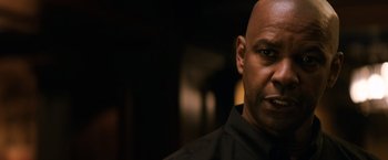 Movie still from “The Equalizer” (2014), directed by Antoine Fuqua – A bald man in a black shirt is looking straight ahead; Close Up shot, Over the shoulder angle