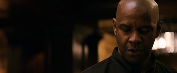 Movie still from “The Equalizer” (2014), directed by Antoine Fuqua – A bald man in a black shirt is looking at the camera; Close Up shot, Low angle
