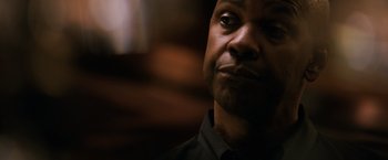 Movie still from “The Equalizer” (2014), directed by Antoine Fuqua – A man's face in a dark room; Close Up shot, Over the shoulder angle