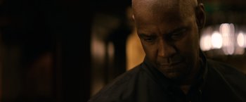 Movie still from “The Equalizer” (2014), directed by Antoine Fuqua – A man with a bald head is looking down; Close Up shot, Low angle