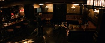 Movie still from “The Equalizer” (2014), directed by Antoine Fuqua – A group of people laying on the ground in a room; Wide shot, High angle