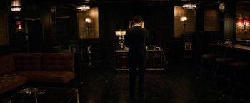 Movie still from “The Equalizer” (2014), directed by Antoine Fuqua – A man standing in front of a desk in a dark room; Wide shot, High angle