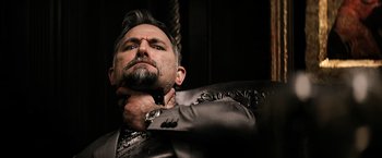 Movie still from “The Equalizer” (2014), directed by Antoine Fuqua – A man in a suit and tie holding his collar; Close Up shot, Low angle