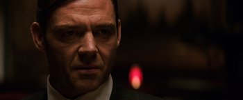 Movie still from “The Equalizer” (2014), directed by Antoine Fuqua – A person wearing a suit and tie; Close Up shot, Low angle