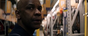 Movie still from “The Equalizer” (2014), directed by Antoine Fuqua – A man's face in a store; Close Up shot, Over the shoulder angle