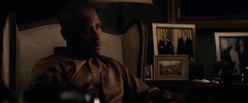 Movie still from “The Equalizer” (2014), directed by Antoine Fuqua – A man sitting in a chair in front of a picture of a woman; Close Up shot, Over the shoulder angle