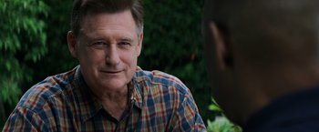 Movie still from “The Equalizer” (2014), directed by Antoine Fuqua – An older man wearing a checkered button down shirt; Close Up shot, Over the shoulder angle