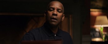 Movie still from “The Equalizer” (2014), directed by Antoine Fuqua – A bald man in a black shirt is looking down; Close Up shot, Low angle
