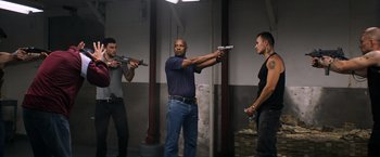 Movie still from “The Equalizer” (2014), directed by Antoine Fuqua – A group of men holding guns in a room; Medium shot, Low angle