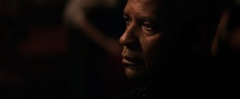 Movie still from “The Equalizer” (2014), directed by Antoine Fuqua – A person's face in the dark; Close Up shot, Over the shoulder angle