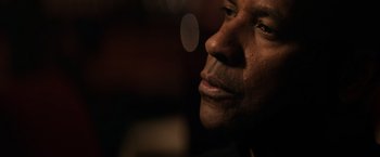 Movie still from “The Equalizer” (2014), directed by Antoine Fuqua – A man's face in a dimly - lit room; Close Up shot, Low angle