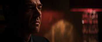 Movie still from “The Equalizer” (2014), directed by Antoine Fuqua – A man's face in front of an orange background; Close Up shot, Low angle