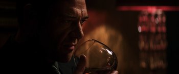 Movie still from “The Equalizer” (2014), directed by Antoine Fuqua – A person holding a glass of wine; Close Up shot, Low angle