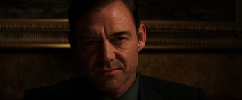 Movie still from “The Equalizer” (2014), directed by Antoine Fuqua – A person wearing a suit and tie; Close Up shot, Low angle