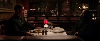 Movie still from “The Equalizer” (2014), directed by Antoine Fuqua – A table set for a meal in front of a bar; Wide shot, Over the shoulder angle
