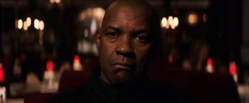 Movie still from “The Equalizer” (2014), directed by Antoine Fuqua – A man with a bald head is looking at the camera; Close Up shot, Over the shoulder angle