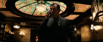 Movie still from “The Equalizer” (2014), directed by Antoine Fuqua – A man talking on a cell phone; Medium shot, Low angle