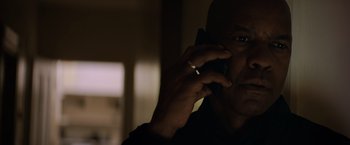 Movie still from “The Equalizer” (2014), directed by Antoine Fuqua – A person talking on a cell phone; Close Up shot, Low angle