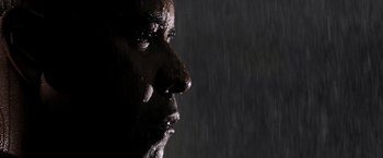 Movie still from “The Equalizer” (2014), directed by Antoine Fuqua – A man's face in the rain; Extreme Close Up shot, Low angle