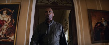 Movie still from “The Equalizer” (2014), directed by Antoine Fuqua – A man standing in front of an open door; Medium shot, Low angle