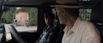 Movie still from “The Equalizer 3” (2023), directed by Antoine Fuqua – A man and a boy sitting in the back of a car; Close Up shot, Over the shoulder angle