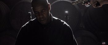 Movie still from “The Equalizer 3” (2023), directed by Antoine Fuqua – A man in a black shirt is in the dark; Close Up shot, Low angle