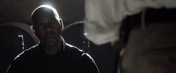 Movie still from “The Equalizer 3” (2023), directed by Antoine Fuqua – A man with a microphone in his hand; Close Up shot, Over the shoulder angle