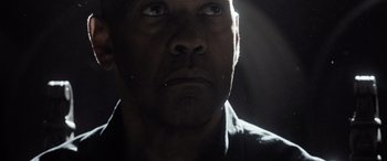 Movie still from “The Equalizer 3” (2023), directed by Antoine Fuqua – A man's face in the dark; Close Up shot, Low angle