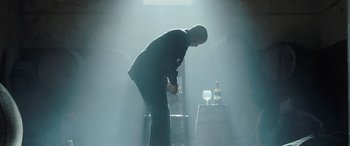Movie still from “The Equalizer 3” (2023), directed by Antoine Fuqua – A man standing in the middle of a dark room; Medium shot, Low angle