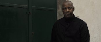 Movie still from “The Equalizer 3” (2023), directed by Antoine Fuqua – An older man standing in front of a green door; Close Up shot, Low angle