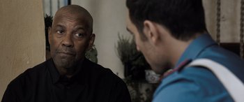 Movie still from “The Equalizer 3” (2023), directed by Antoine Fuqua – Two men talking to each other in front of a plant; Close Up shot, Over the shoulder angle