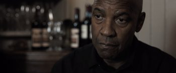 Movie still from “The Equalizer 3” (2023), directed by Antoine Fuqua – A person wearing a black shirt; Close Up shot, Over the shoulder angle