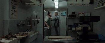 Movie still from “The Equalizer 3” (2023), directed by Antoine Fuqua – Two men in a kitchen with a mirror; Medium shot, Over the shoulder angle