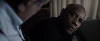 Movie still from “The Equalizer 3” (2023), directed by Antoine Fuqua – A person sitting in a room; Close Up shot, Over the shoulder angle