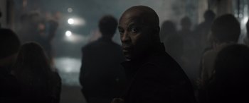 Movie still from “The Equalizer 3” (2023), directed by Antoine Fuqua – A man in a black jacket is looking at the camera; Close Up shot, Over the shoulder angle