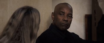 Movie still from “The Equalizer 3” (2023), directed by Antoine Fuqua – A man with a bald head looking at a woman with blonde hair; Close Up shot, Over the shoulder angle