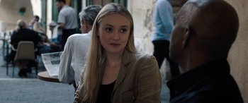 Movie still from “The Equalizer 3” (2023), directed by Antoine Fuqua – A woman with long blonde hair wearing a brown jacket; Close Up shot, Over the shoulder angle