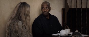 Movie still from “The Equalizer 3” (2023), directed by Antoine Fuqua – A man sitting at a table next to a woman; Medium shot, Over the shoulder angle