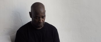 Movie still from “The Equalizer 3” (2023), directed by Antoine Fuqua – A man with a bald head is looking down; Close Up shot, Low angle