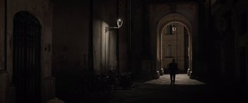 Movie still from “The Equalizer 3” (2023), directed by Antoine Fuqua – A person walking down a dark alley way; Extreme Wide shot, Low angle