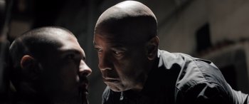 Movie still from “The Equalizer 3” (2023), directed by Antoine Fuqua – A man with a bald head looking at another man with a shaved head; Close Up shot, Over the shoulder angle