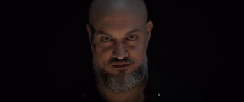 Movie still from “The Equalizer 3” (2023), directed by Antoine Fuqua – A bald man with a beard and a mustache; Close Up shot, Low angle