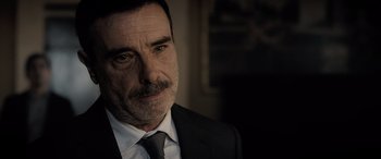 Movie still from “The Equalizer 3” (2023), directed by Antoine Fuqua – A person wearing a suit and tie; Close Up shot, Over the shoulder angle