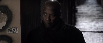 Movie still from “The Equalizer 3” (2023), directed by Antoine Fuqua – A man in a black jacket is looking at the camera; Close Up shot, Low angle