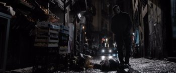 Movie still from “The Equalizer 3” (2023), directed by Antoine Fuqua – A man in a mask lies dead on the street; Wide shot, Low angle