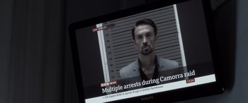 Movie still from “The Equalizer 3” (2023), directed by Antoine Fuqua – A man in a black jacket is on a television screen; Close Up shot, Over the shoulder angle